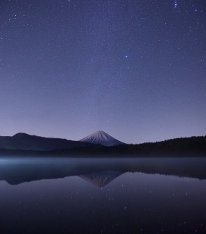 starry sky over mountain lake