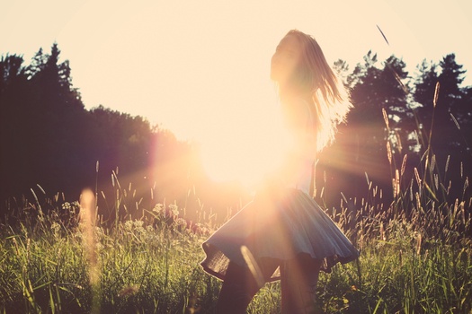 girl in skirt in sunny field