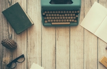 typewriter and paper for writing out a new years resolution