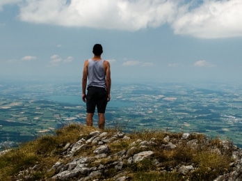 man standing on top of mountain