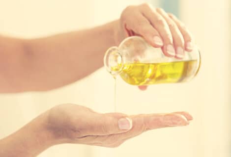 woman pouring oil cleansing oil on hand
