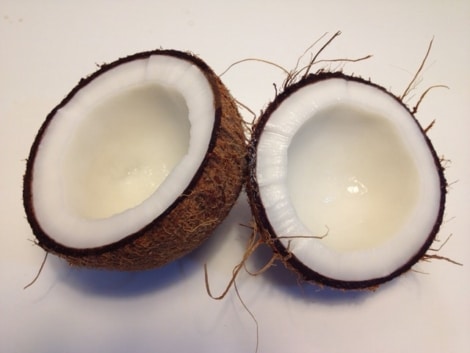 coconut split open with oil inside