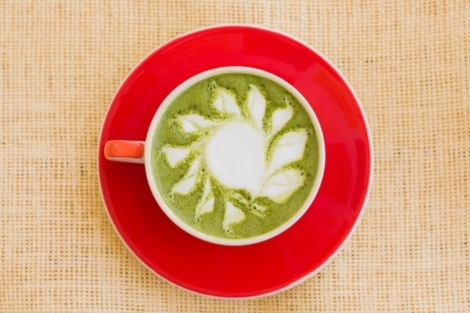 matcha tea in cup on red saucer