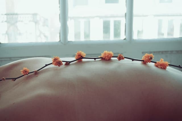 women with flowers on her back