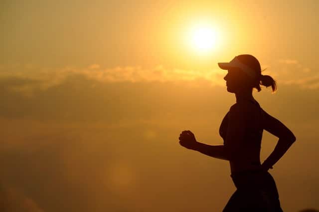 Woman running during sunset