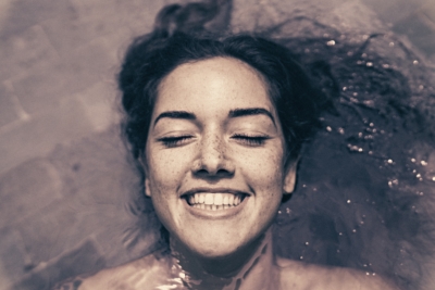 relaxed woman laying in a bathtub