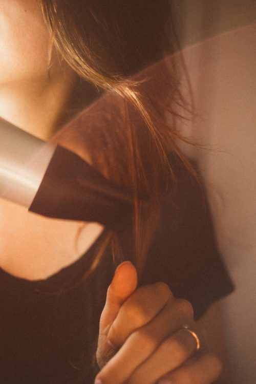 woman blow drying her hair