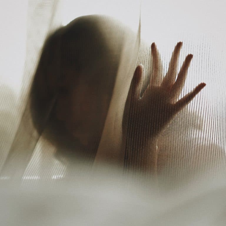 A Woman Behind a Curtain