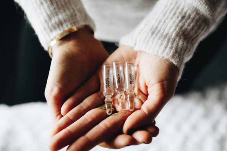 A Person Holding Ampule Bottles