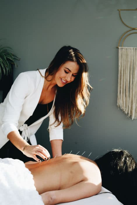 Doctor Caitlin Gordon Performing Acupuncture Treatment - Amaluna Wellness