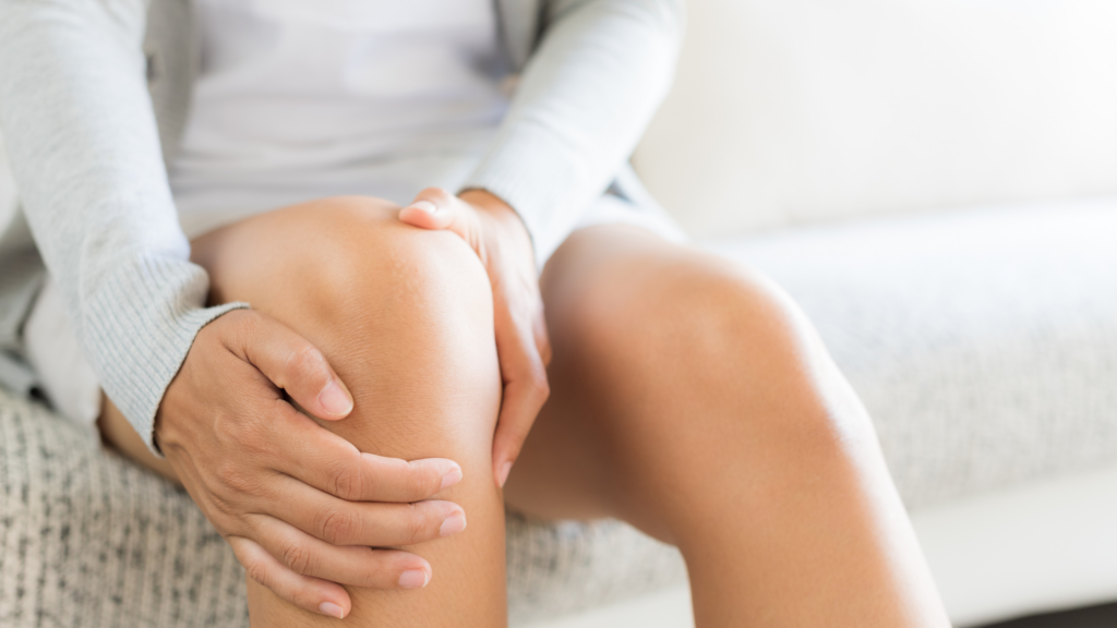 Women holding knee in pain