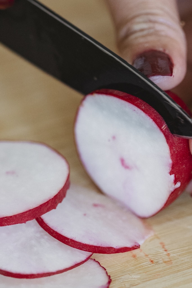 Close-up of Woman Cutting Radish 